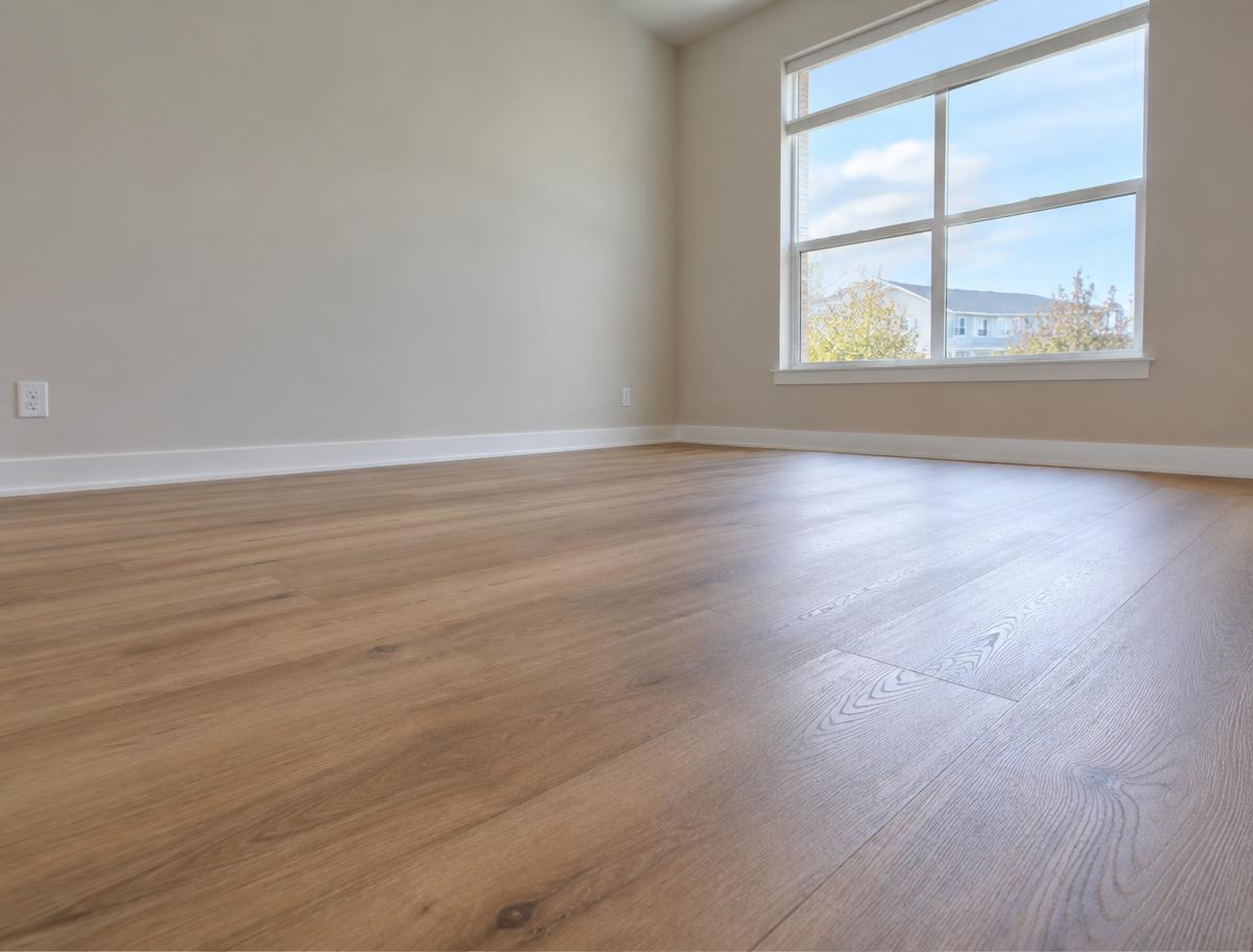Warm wood-look plank flooring in an empty bedroom