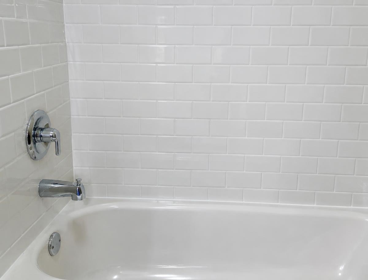 Clean white subway tile tub surround